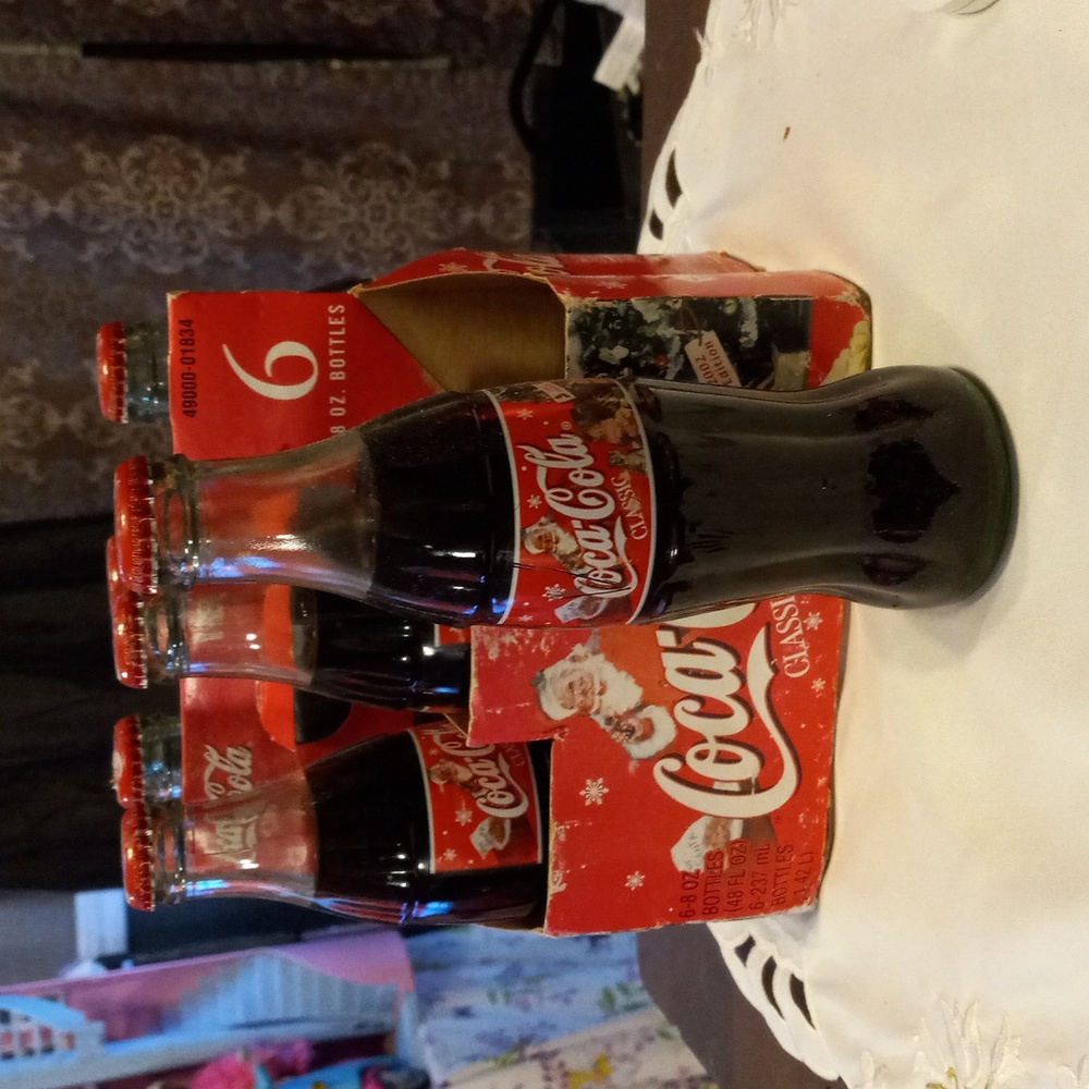 6 small coke special edition 2002 bottles with carry Caddy